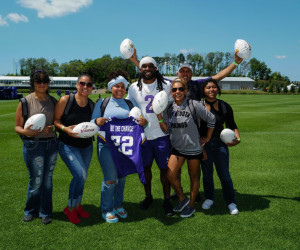 Washburn graduate Elsie with members of the Minnesota Vikings organization