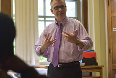 Man speaking in front of a classroom